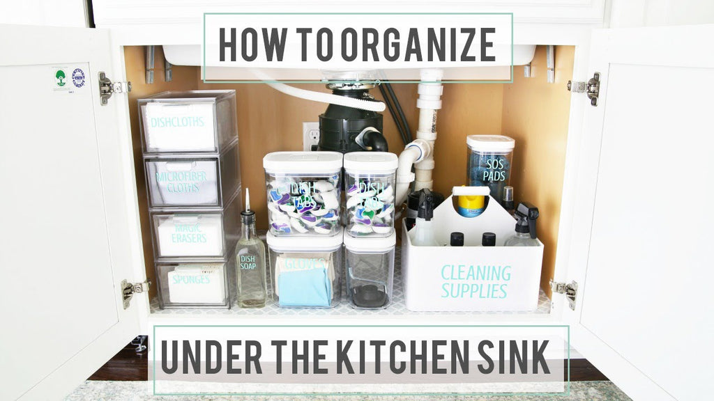 It can be tricky to organize under the kitchen sink! The pipes make the space awkward, and typically we need to store a variety of items there